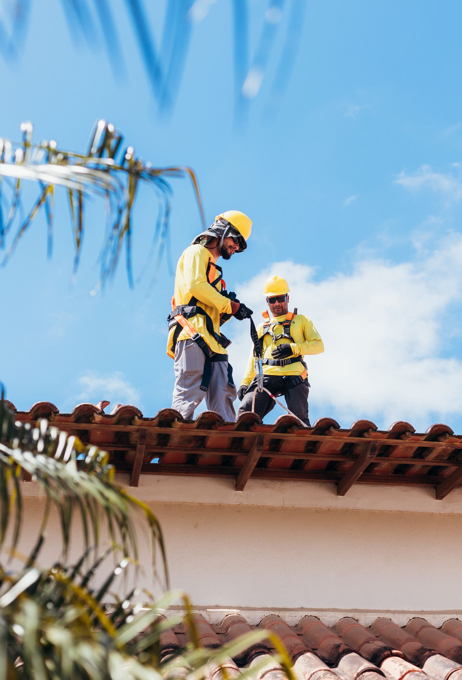 Roofers installing tile roofing material