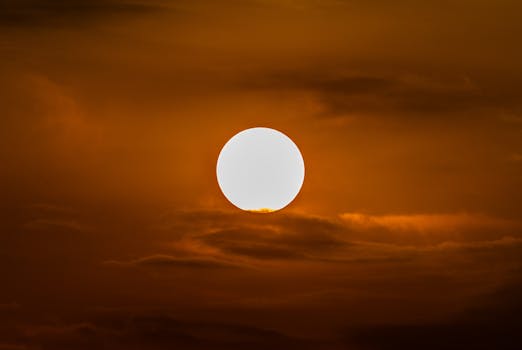 Captivating sunset with a bright sun against an orange sky, perfect for nature themes.