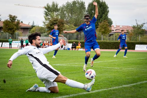 Free Dynamic moment of a soccer game with players in action on a sunny outdoor field. Stock Photo