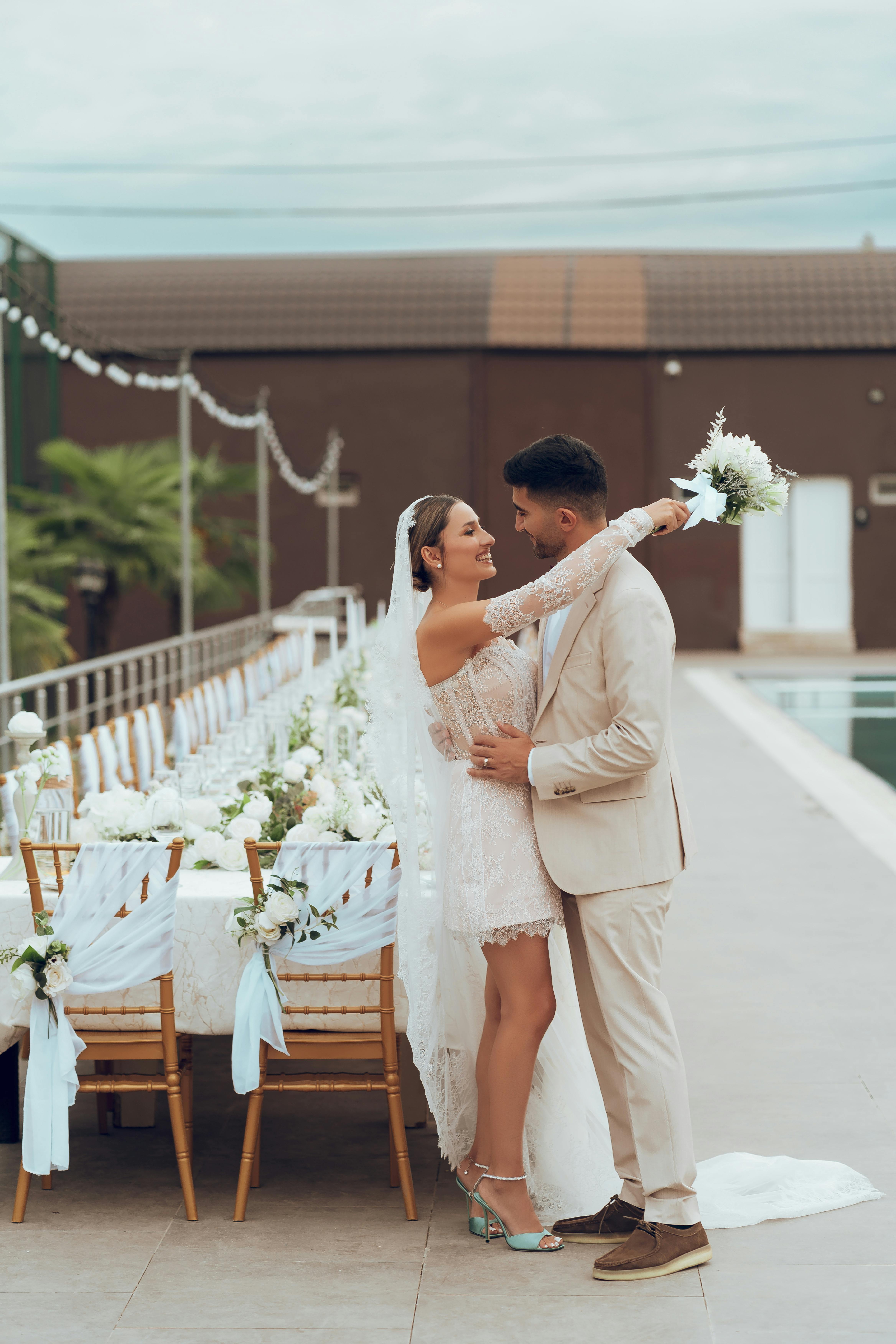 outdoor wedding couple embracing by decorated table