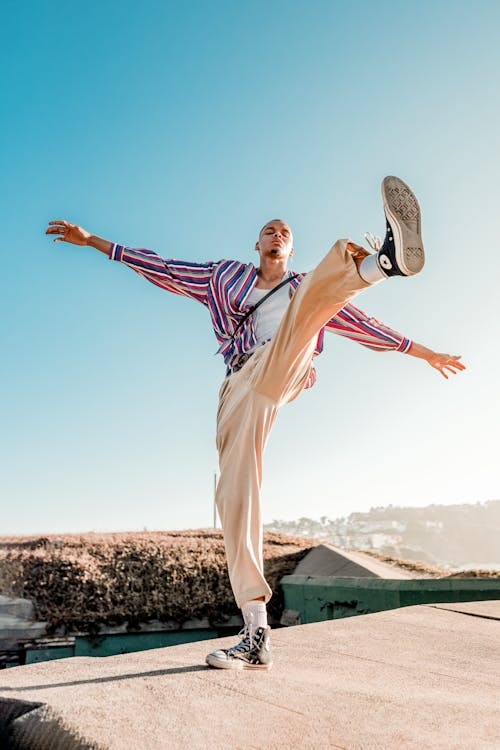 Free Man Wearing White Pants with Left Foot Up Stock Photo