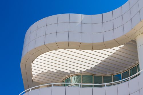 Free Low-angle view of the Getty Center's modern architecture with curved lines and glass windows. Stock Photo