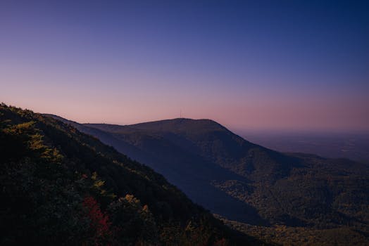 Breathtaking mountain landscape under a clear twilight sky, showcasing natural beauty and tranquility.