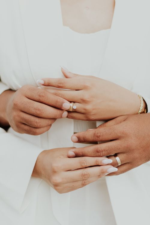 Free Close-up of a couple's hands with wedding rings, symbolizing love and commitment. Stock Photo