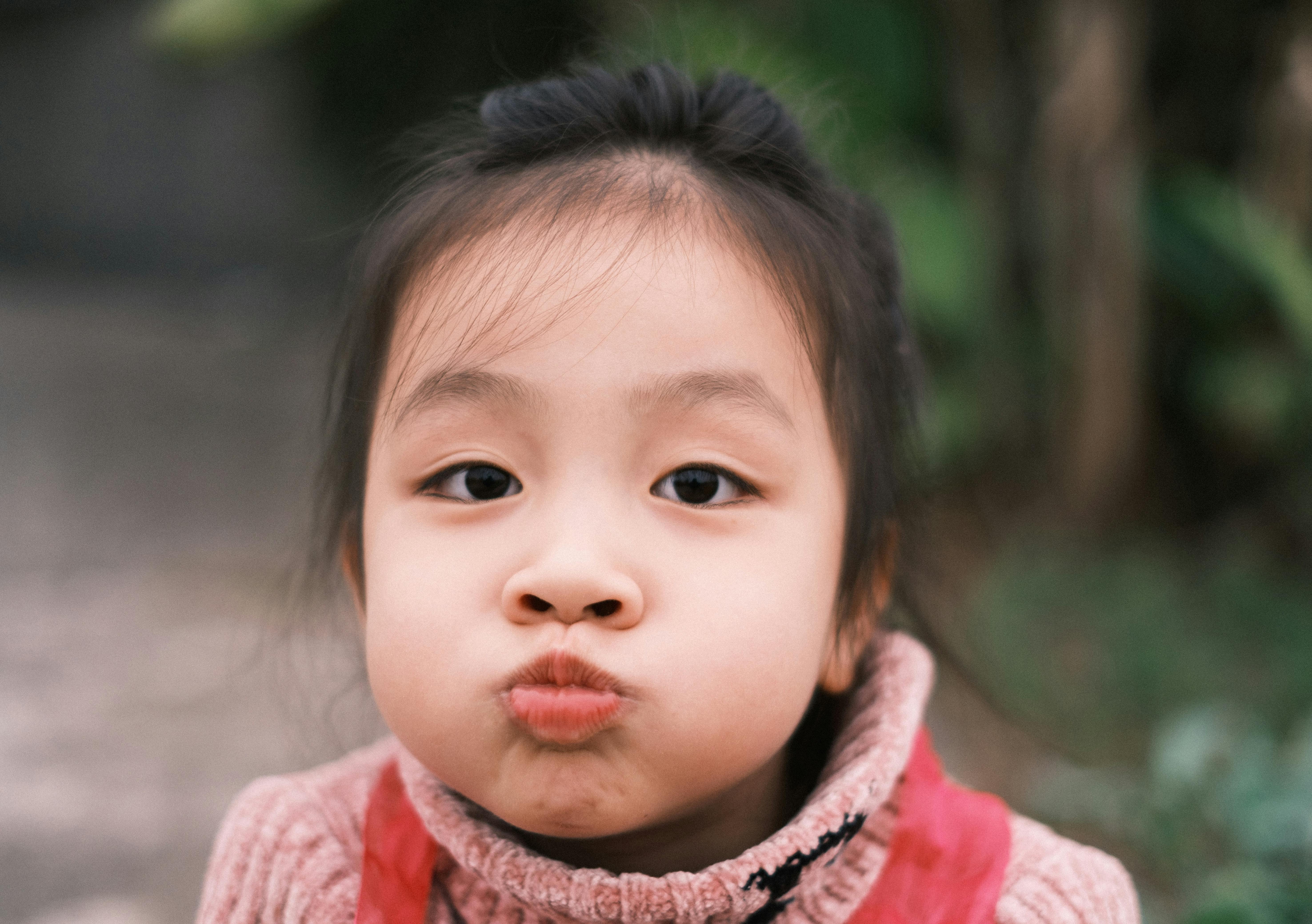 cute child making funny face outdoors