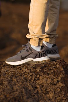 Detailed shot of stylish sneakers on rugged terrain, perfect for lifestyle and fashion themes.