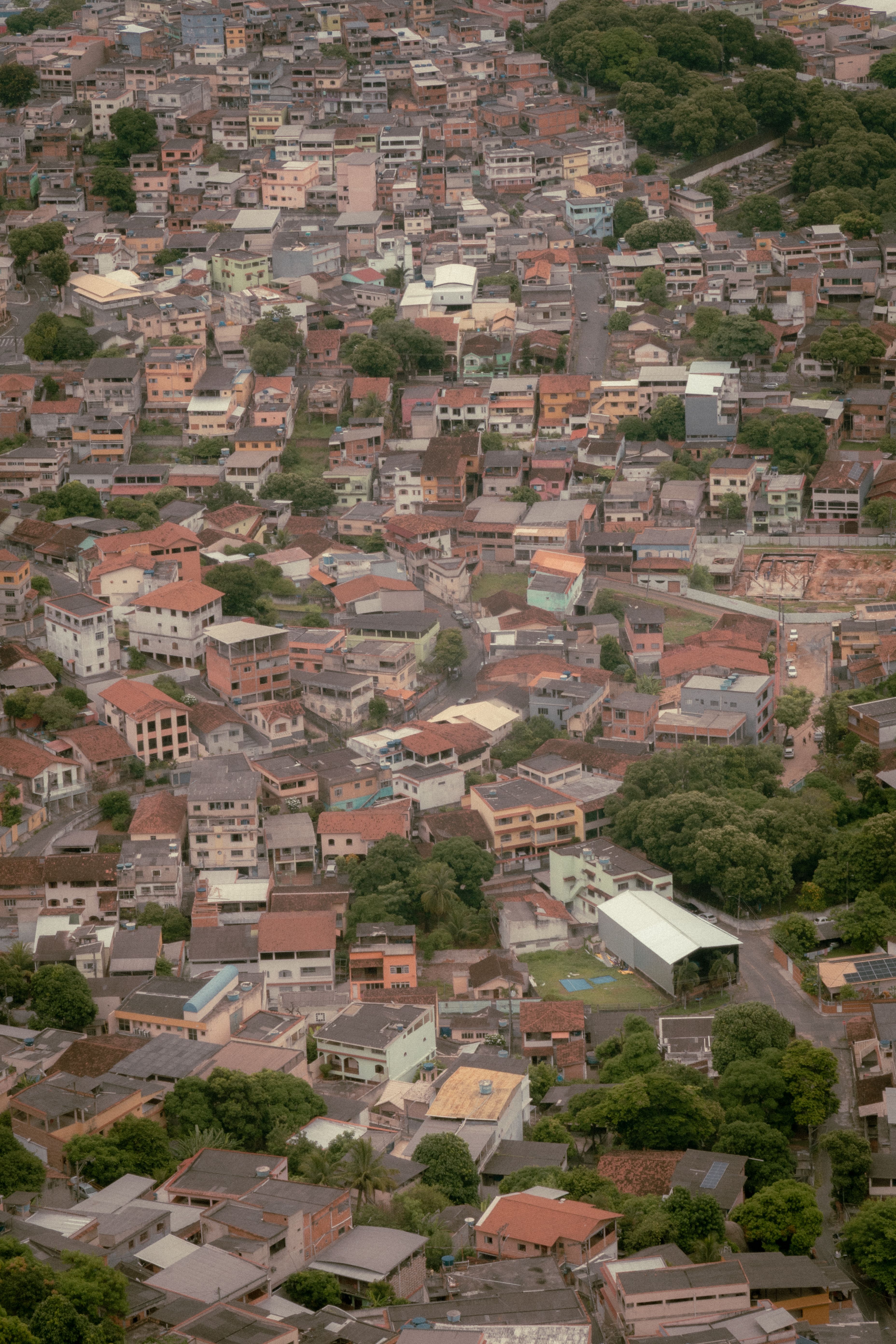 High-angle shot of the densely packed roofs and streets of Vitoria, ES, Brazil.