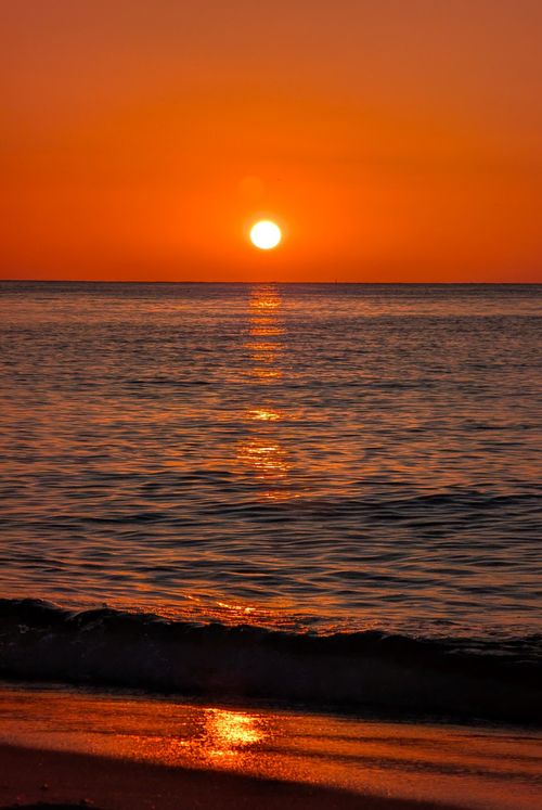 Free Stunning sunset in Cape May, NJ, casting vibrant colors across the ocean. Tranquil and scenic view. Stock Photo