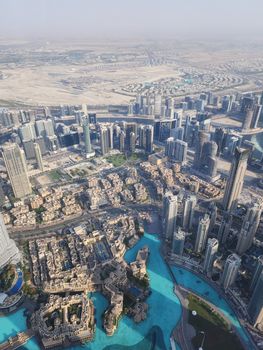 Stunning aerial shot of Dubai's modern architecture featuring towering skyscrapers and azure water bodies.