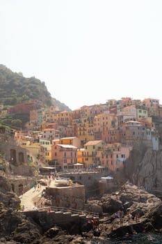 Scenic view of colorful houses on a cliff in Cinqueterre, Italy, capturing the vibrant charm of the Italian coastline.