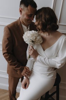 A romantic and intimate indoor wedding portrait of a happy couple.