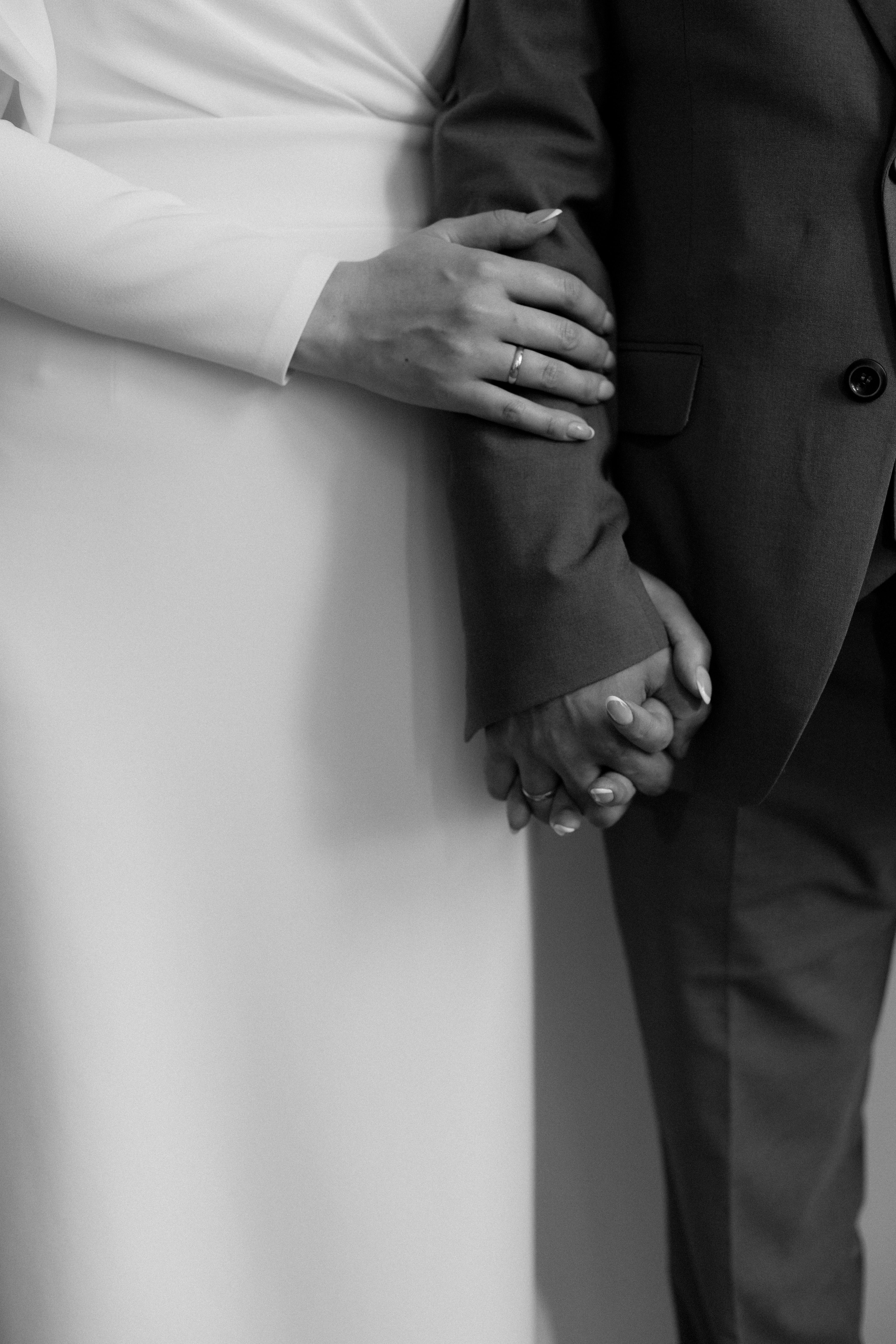 Elegant Black and White Wedding Couple Holding Hands · Free Stock Photo