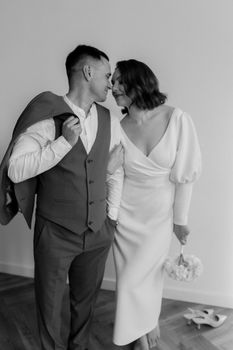 Black and white photo of a couple sharing a tender moment on their wedding day.