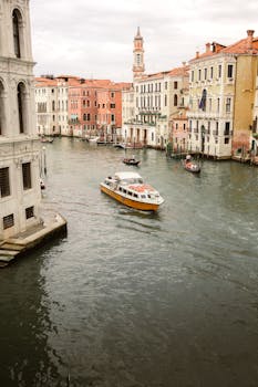 Charming Venice canal scene with boats and historic architecture, perfect for travel inspiration.