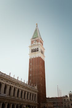 Elegant view of St. Mark's Campanile against a clear sky in Venice, Italy.