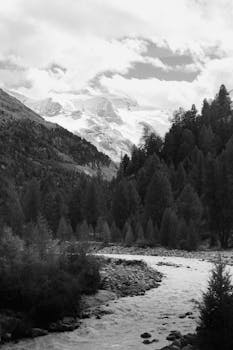 Stunning black and white view of mountains and river in Zermatt, Switzerland.