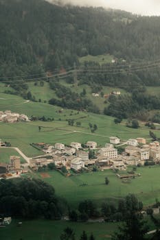 Scenic aerial view of Saint Moritz village and lush greenery in Switzerland during summer.