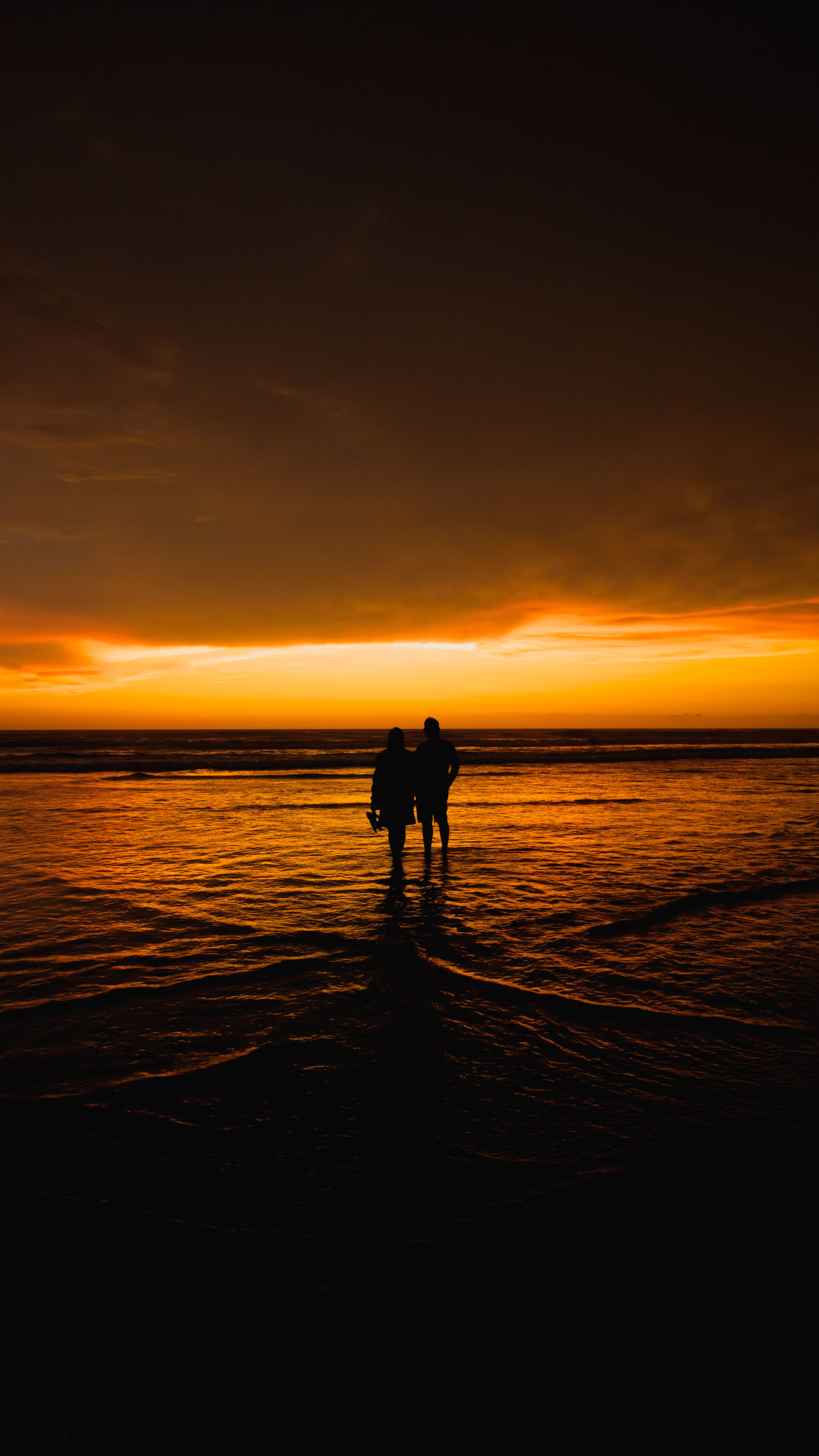 Silhouette of Couple Embracing at Sunset Beach · Free Stock Photo