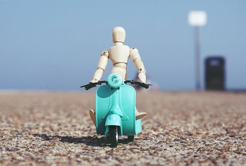 Robot Toy Riding A Scooter