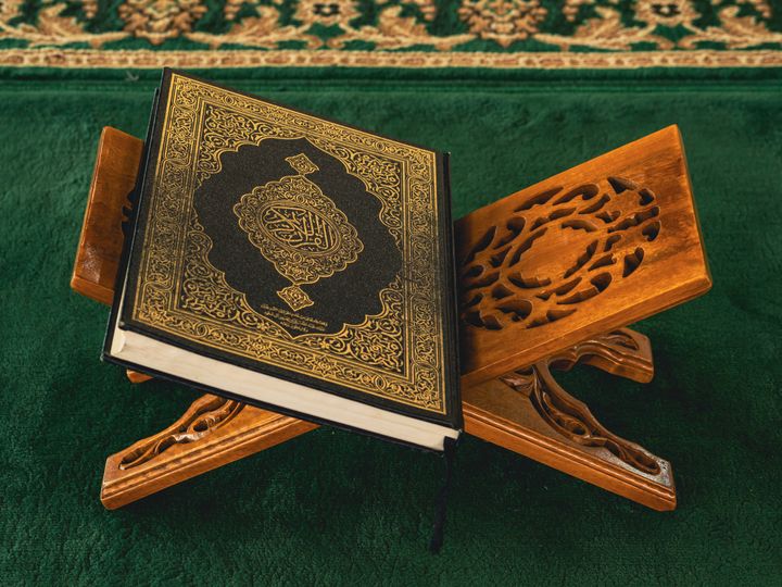 Quran on an ornate wooden rehal