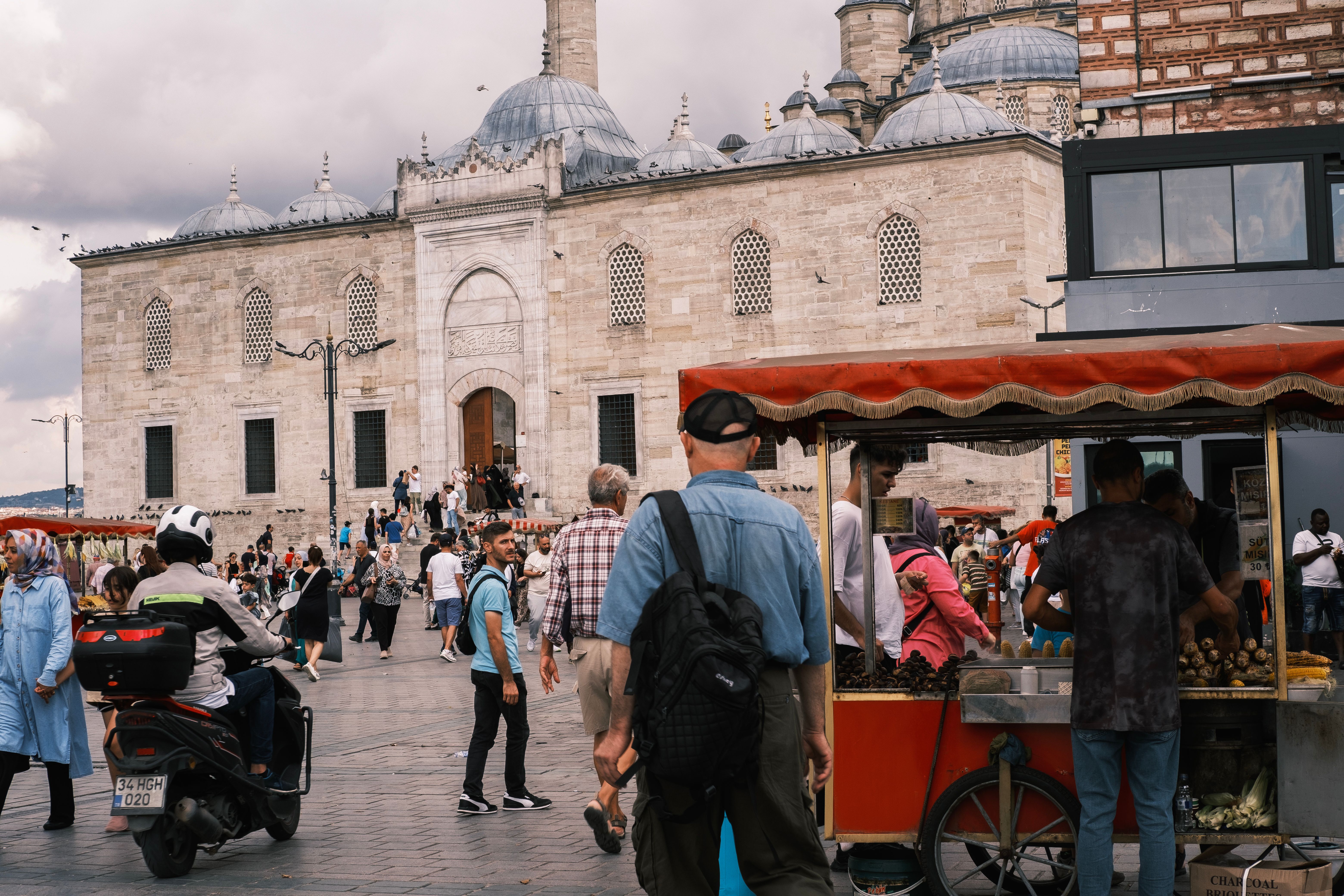 Street vendor soliciting tourists on street, a common tactic used to lure visitors into scams
