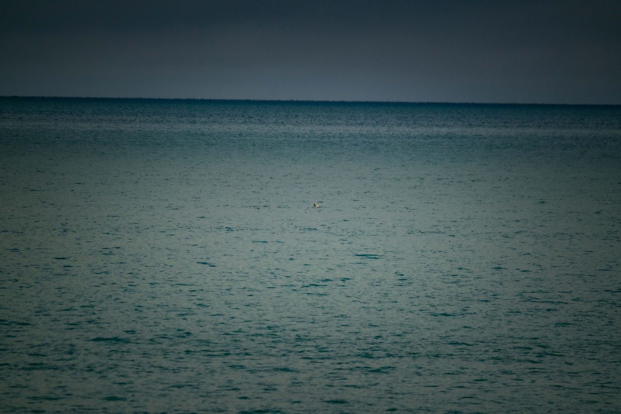 serene view of a calm sea under a cloudy sky perfect for relaxation th