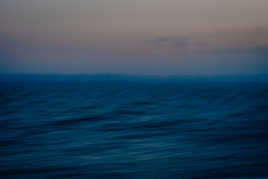 Abstract view of a calm ocean under a twilight sky with soothing colors.