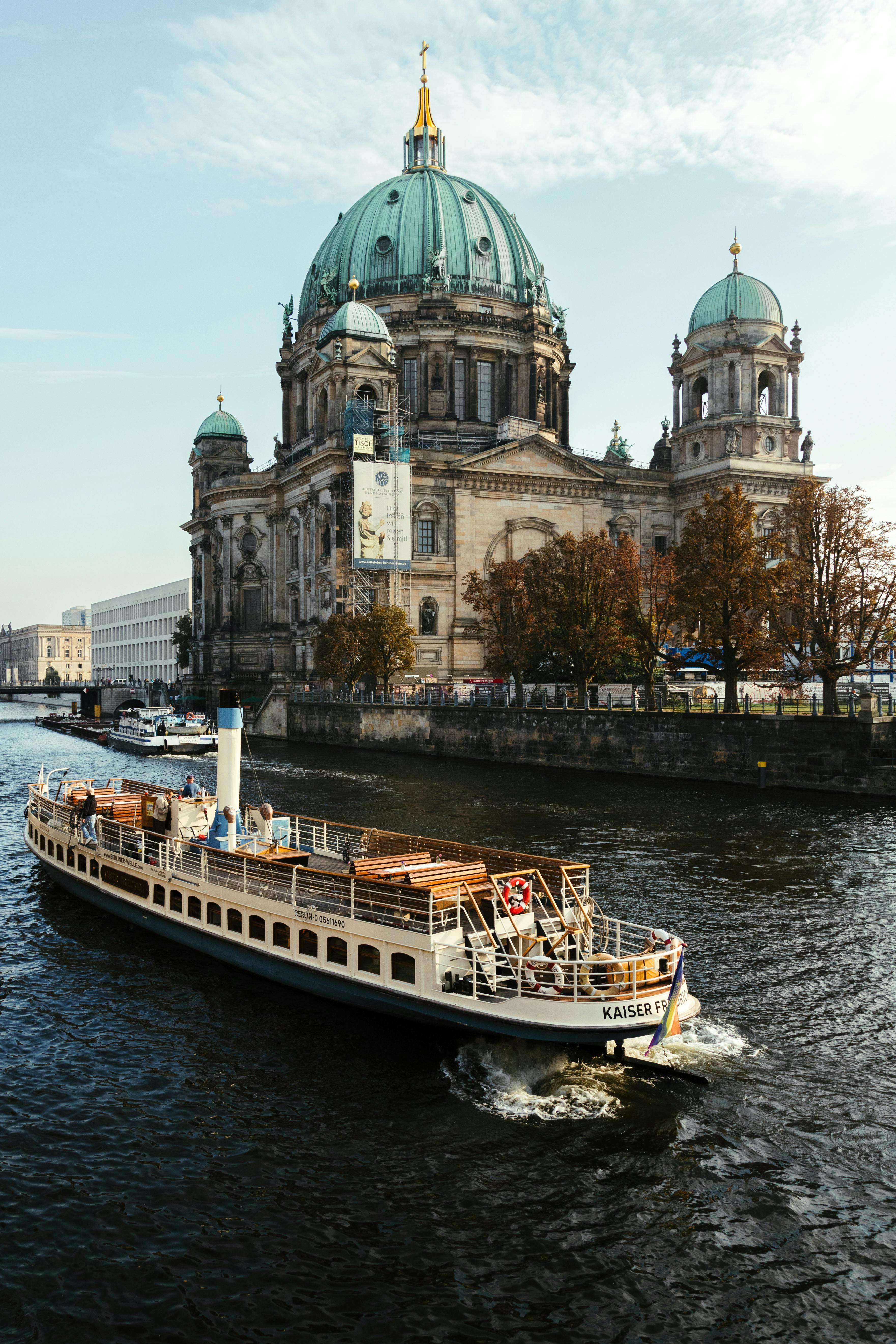 scenic view of berlin cathedral with boat on spree river