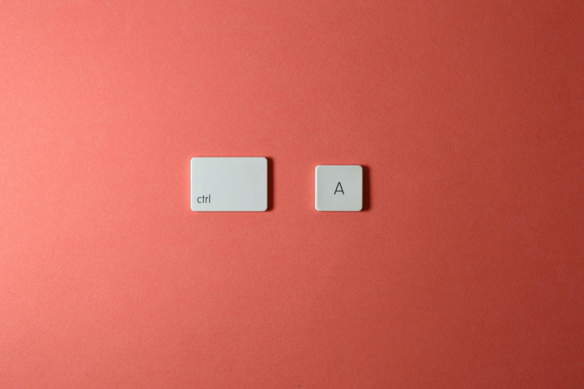 White ctrl and A keys on a simple red background create a minimalist and modern look.