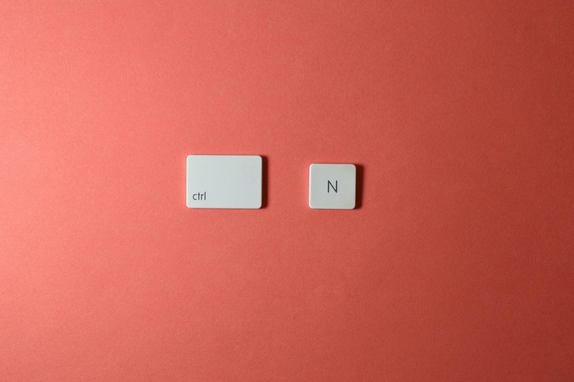 Two keyboard keys on a red background, depicting 'ctrl' and 'N'.