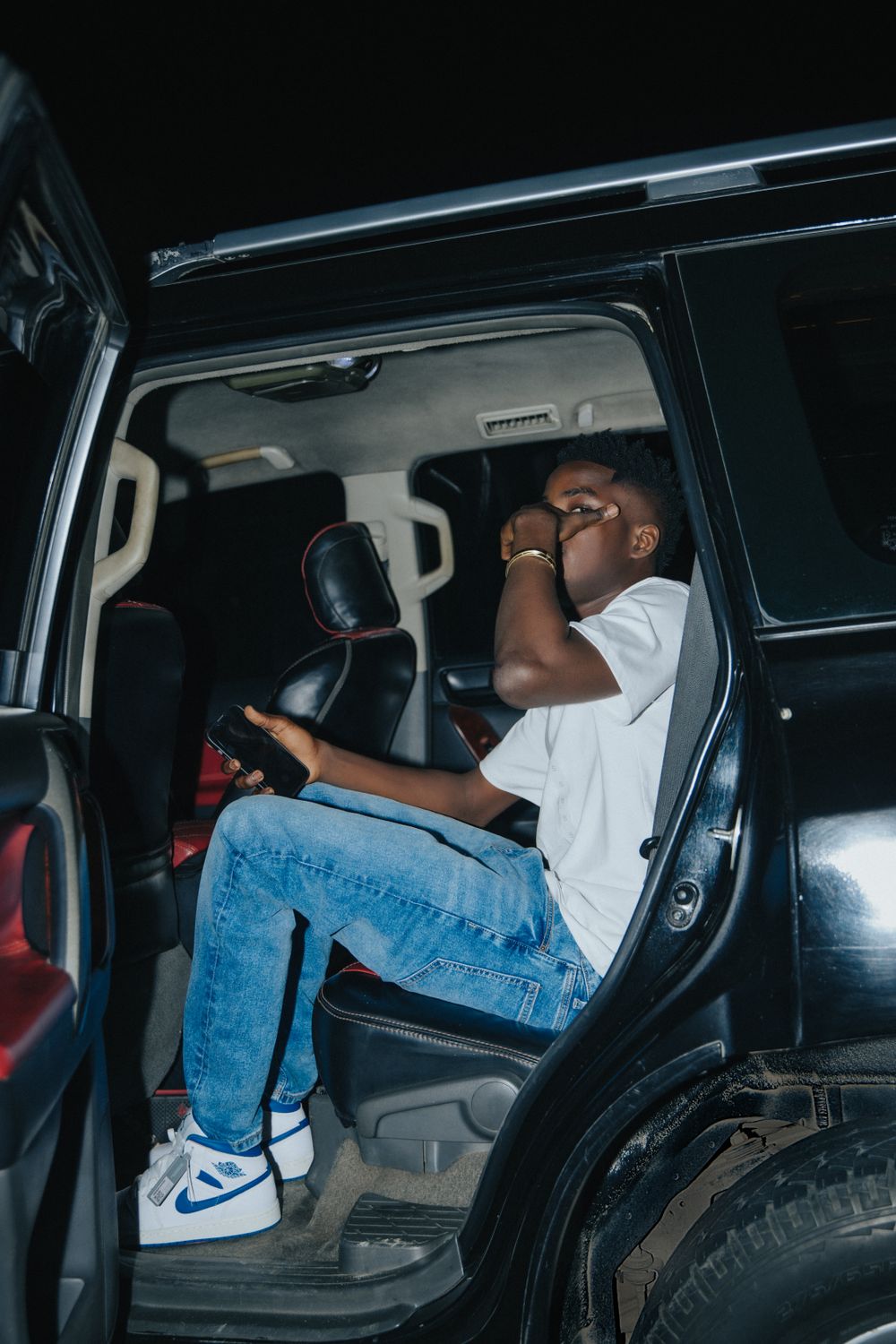 Young man sitting in a car at night · Free Stock Photo
