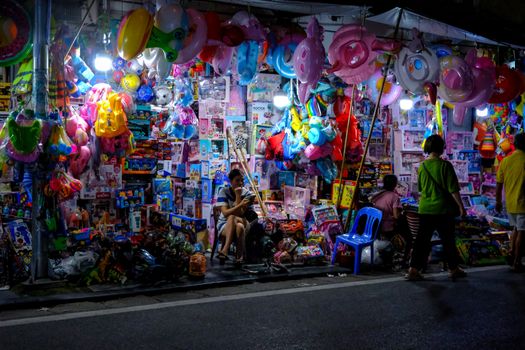 Vibrant toy stall at a night market showcasing colorful toys and decorations.