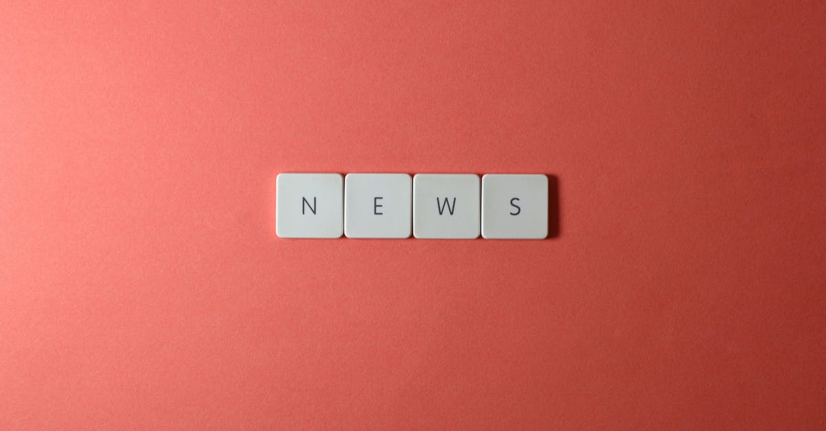 Close-up of keyboard keys spelling 'NEWS' on a red background, minimalist style.