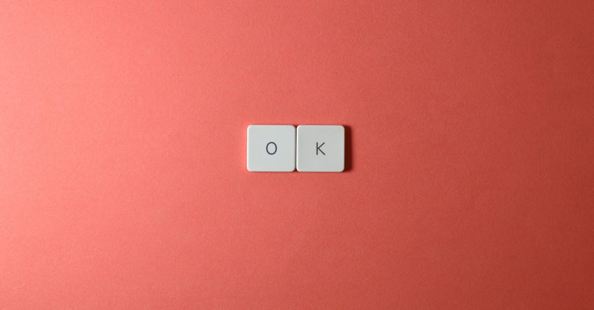 Two white keyboard keys spelling 'OK' on a red surface, minimalist style.