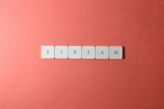 Simple and elegant arrangement of STREAM spelled with keyboard keys on a red backdrop, perfect for creative projects.