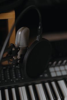 Close-up of a studio microphone and keyboard, perfect for music production.