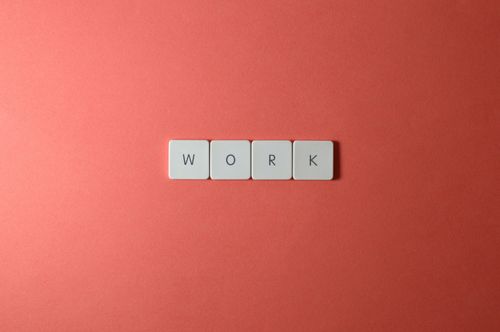 Free Minimalist image featuring the word 'work' with keyboard keys on a coral background. Perfect for workplace or business themes. Stock Photo