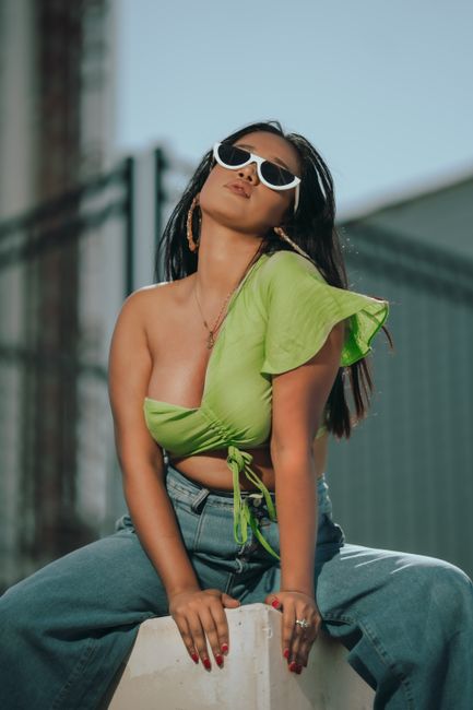 Stylish young woman in a vibrant outfit posing confidently outdoors in New York. Urban chic fashion photography.