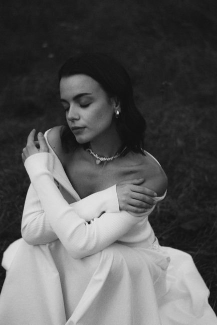 Serene black and white portrait of a woman in nature, exuding calmness.