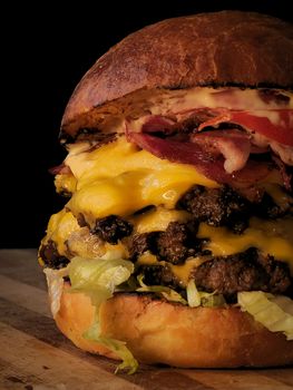 Tantalizing double cheeseburger topped with bacon and lettuce, perfect for food lovers.