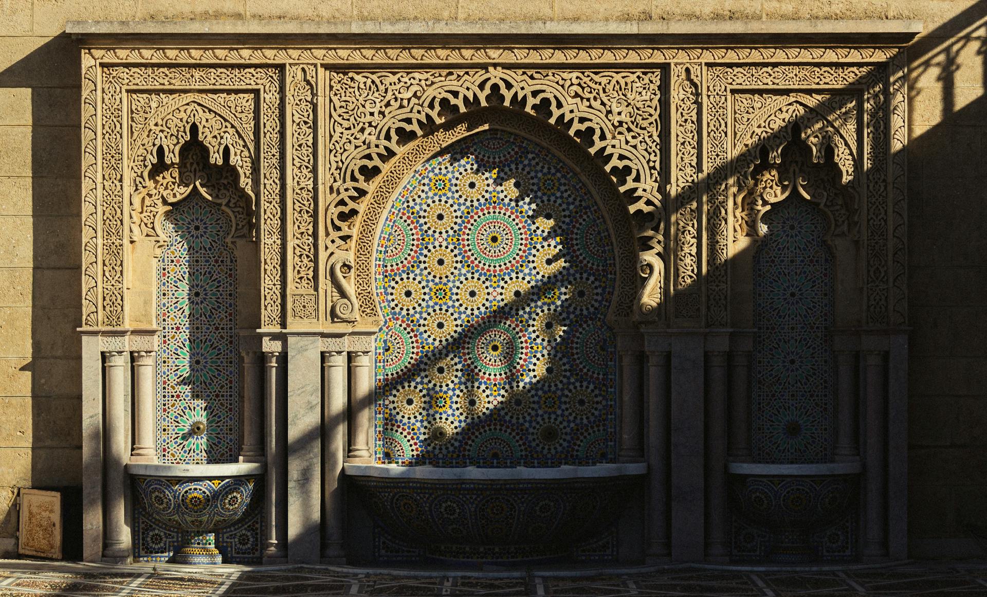 A detailed Moroccan mosaic fountain with intricate arches and geometric patterns.