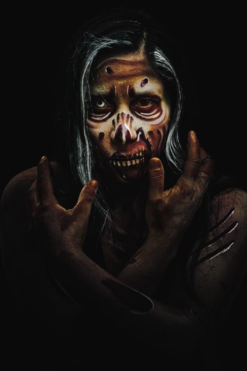 Free Intense zombie makeup portrait capturing a chilling and eerie mood. Stock Photo