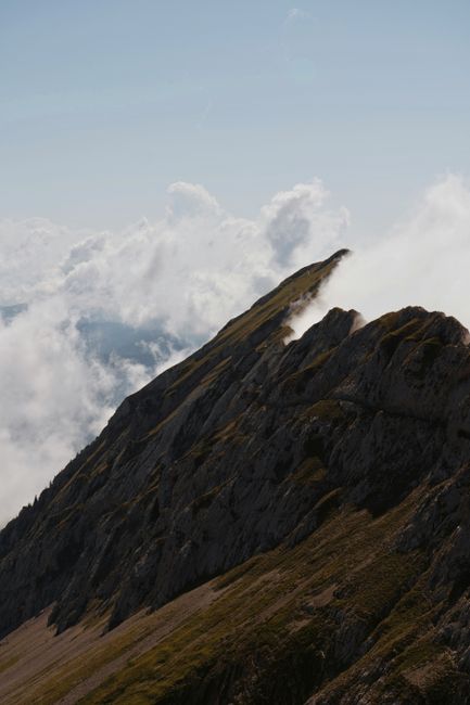 Mountain peaks emerging through clouds, offering a stunning natural view.