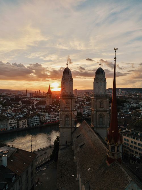 Free Aerial view of Zurich's iconic twin towers at sunset with vibrant sky. Stock Photo