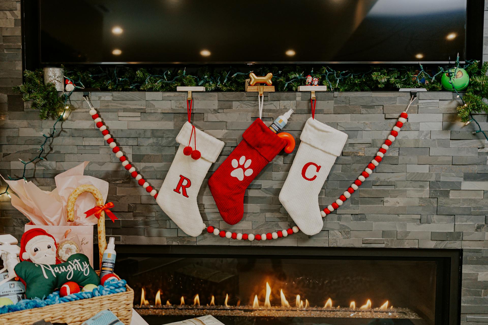 A cozy Christmas fireplace with stockings and festive decorations