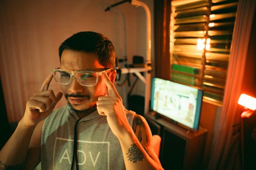 Free Focused man with glasses in dimly lit room, reflecting concentration and deep thinking. Stock Photo