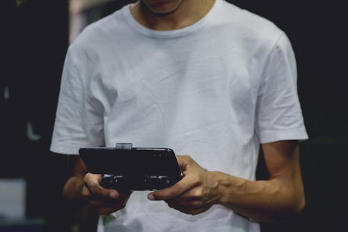 A Smartphone Game Controller On A Person's Hand