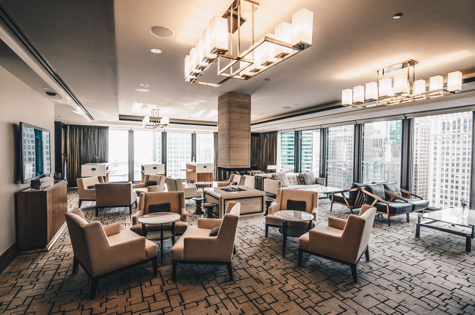 Spacious, modern hotel lounge area with a cityscape view in Chicago, featuring stylish furniture. Related image for 2025 Africa Hospitality Startup Showcase.