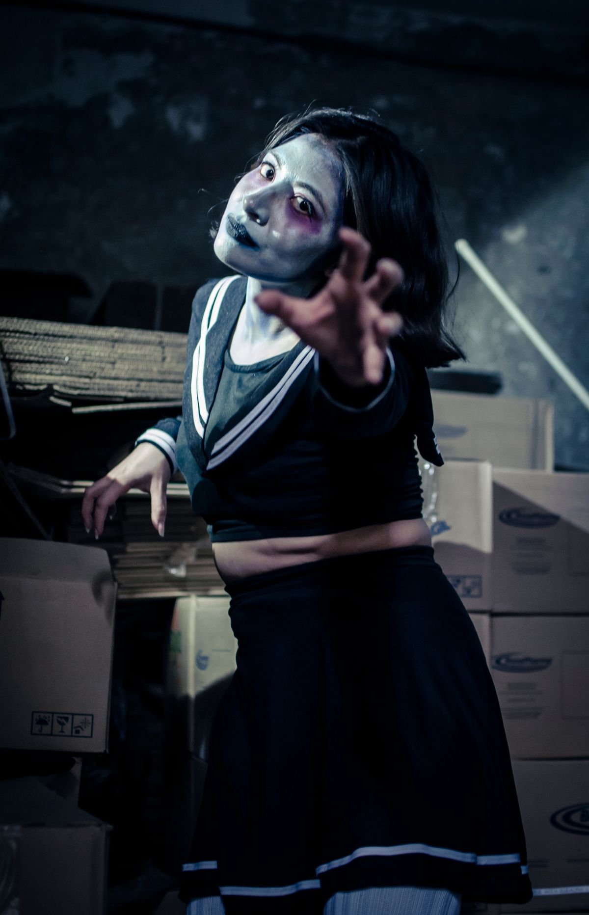 Adult dressed as a zombie with horror makeup in an abandoned warehouse for halloween costume ideas for adults