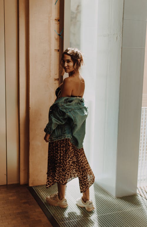 Photo Of Woman Standing Beside The Wall